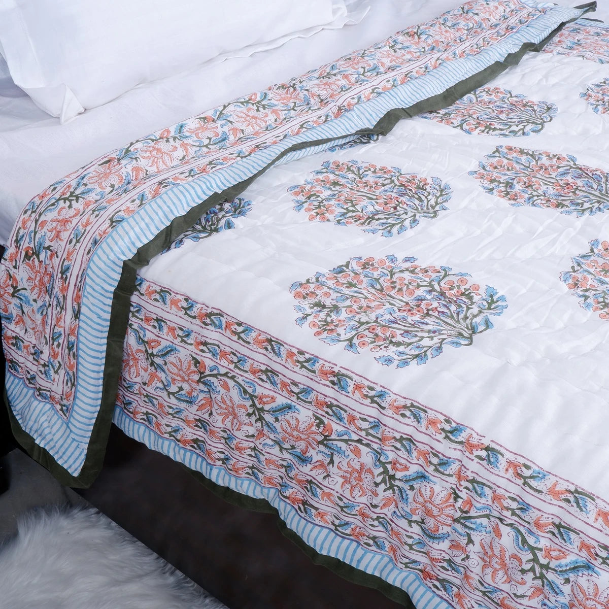 Jaipuri cotton quilt single bed featuring intricate floral patterns and a vibrant border